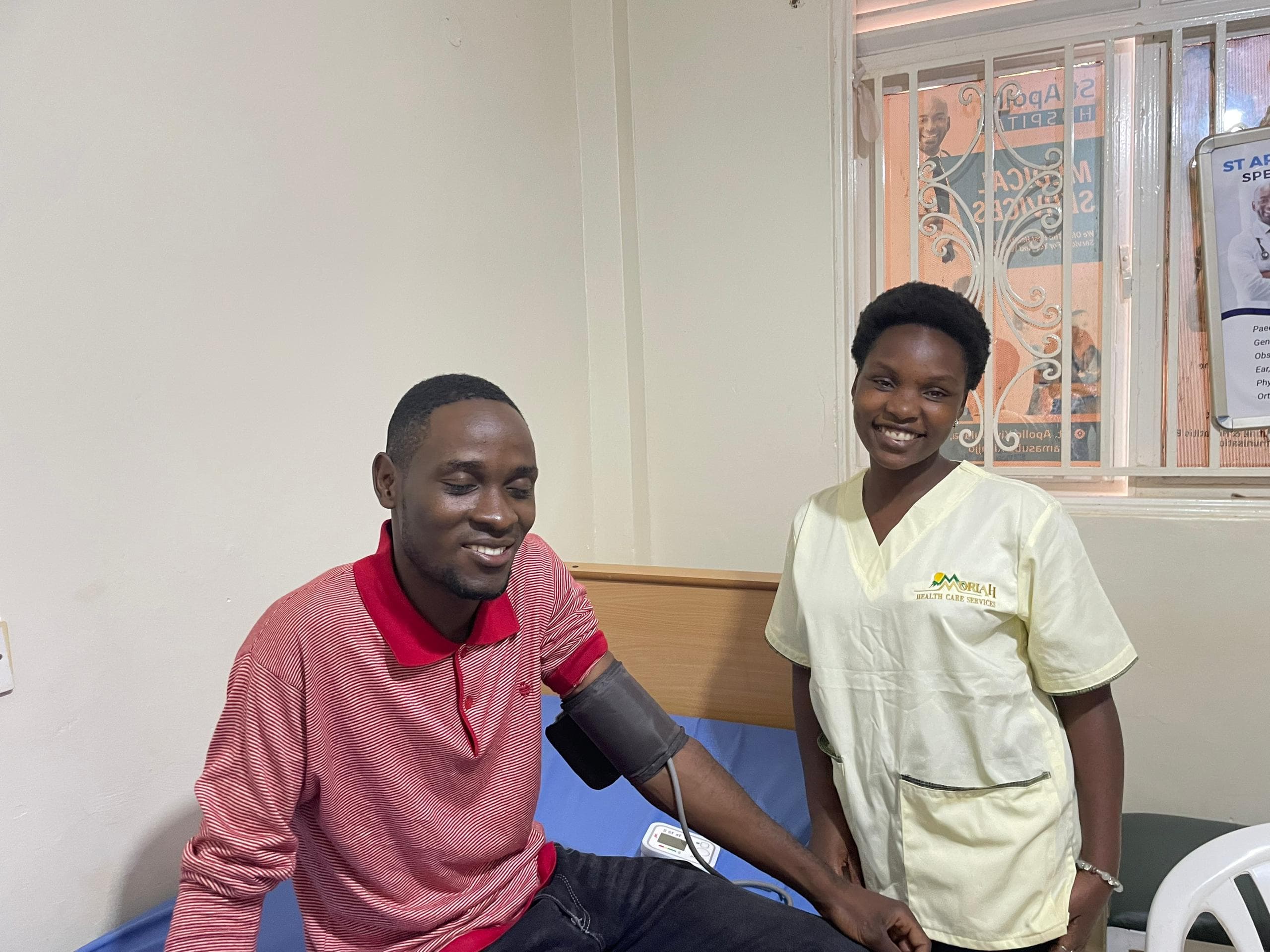 A Moriah carer checking a patient's blood pressure